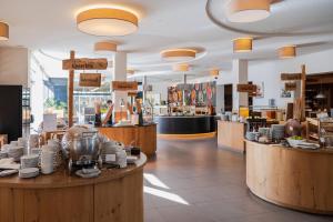 a store with wooden counters and dishes on display at Alpenhotel Kaiserfels in Sankt Johann in Tirol