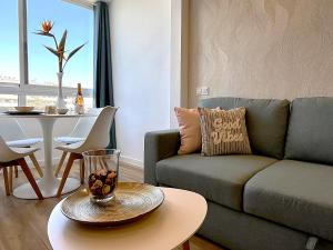 a living room with a couch and a table at Hero Apartment - Luxury in Maspalomas in Maspalomas
