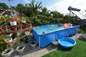 a hot tub and a roller coaster in a garden at Casa Morena Tuzla in Tuzla