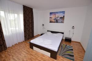 a bedroom with a white bed in a room at Casa Morena Tuzla in Tuzla +114 photos