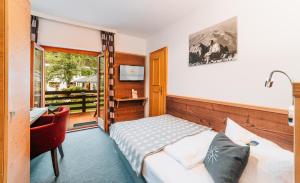 Postel nebo postele na pokoji v ubytování Hotel Alpensonne