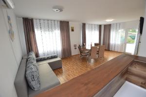 a living room with a couch and a table at Casa Morena Tuzla in Tuzla