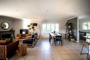a living room with a couch and a table at Happy Hideaway in Hermanus