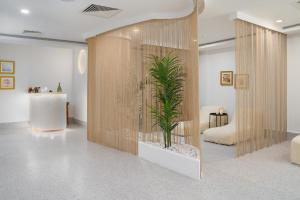 a room with a potted plant in a wall at Ölüdeniz Blu Luxury Unique Hotel - Adults-Only in Oludeniz