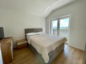 a bedroom with a bed and a large window at Villa Mirta in Zmijavci +37 photos