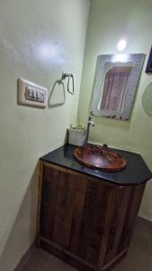a bathroom with a wooden sink and a mirror at Malgudi Mane Homestay in Chikmagalūr +25 photos