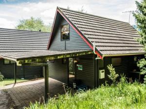 a black house with a window on the side of it at Snow Chalet - Ohakune Chalet in Ohakune