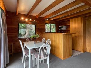 a dining room with a table and chairs at Snow Chalet - Ohakune Chalet in Ohakune