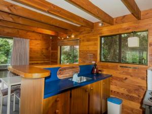 a kitchen with a blue counter in a wooden cabin at Snow Chalet - Ohakune Chalet in Ohakune