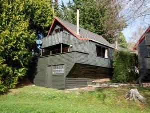 a gray house with a gambrel roof at Snow Chalet - Ohakune Chalet in Ohakune +6 photos