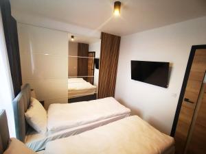 Posteľ alebo postele v izbe v ubytovaní Smart Apartament Grunwaldzka 240