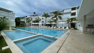 a large swimming pool in front of a building at Nicole Residence in Las Terrenas