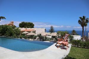 a villa with a swimming pool with a view of the ocean at Frangimare - La Malandrina in Malfa