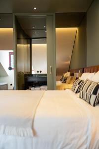 a large bedroom with two beds and a piano at Santo Thyrso Hotel in Santo Tirso