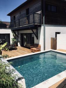 a swimming pool in front of a house at Villa vacance Anglet avec piscine, 1km de la plage in Anglet