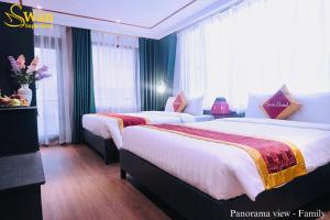 Postel nebo postele na pokoji v ubytování Swan Sapa Hotel