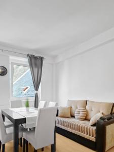 a living room with a couch and a table at Stockerau Family Haven for 4 in Stockerau +13 photos