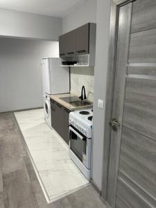 a kitchen with a stove and a refrigerator at Апартамент - Весела улица in Sozopol
