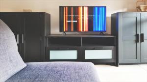 a bedroom with a dresser with a tv on it at Appartamento AURORA in Follonica