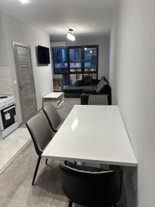 a living room with a white table and chairs at Апартамент - Весела улица in Sozopol