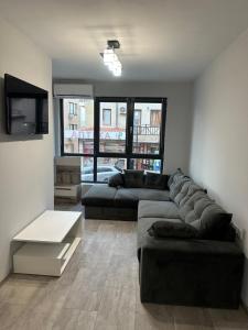 a living room with a couch and a table at Апартамент - Весела улица in Sozopol +8 photos