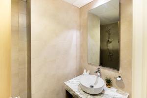 a bathroom with a sink and a shower at Cozy 1 BR apartment in Dubai near Burj khalifa in Dubai +9 photos