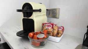 a coffee maker sitting on a counter with a container of food at Studio piscine partagée parking securisé in Saint-Yrieix-sur-Charente