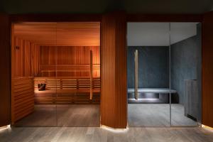 a bathroom with a shower with a glass door at Sheraton Lake Como Hotel in Como
