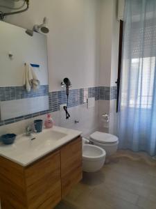 a bathroom with a sink and a toilet at Beach Rooms 1 Self Check-in in Alghero +30 photos