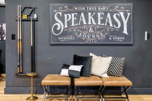 a bench with pillows on it in a room at Slide Speakeasy Movie Room Hot Tub Games Villa in Candler