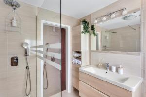 a bathroom with a sink and a shower at Apartments Svetina in Bled +37 photos