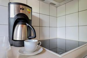a coffee maker and a coffee cup on a counter at Evaggelia's Summer Resort in Dhíkella