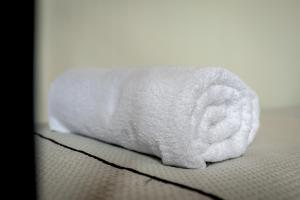 a roll of toilet paper sitting on top of a bed at Evaggelia's Summer Resort in Dhíkella +44 photos
