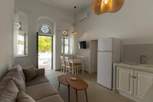 a living room with a couch and a table at Aeris Tinos Suites in Panormos