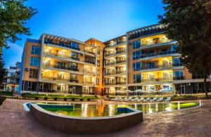 a large building with a fountain in front of it at JOY Studio in Ravda