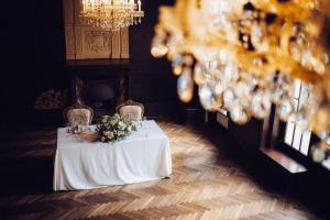 a table with a white table cloth and flowers on it at Pałac Borowa in Borowa