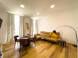 a living room with a couch and a table at City center appartment in Pula