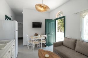a living room with a couch and a table at Aeris Tinos Suites in Panormos