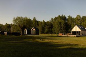 a group of buildings in a field with trees at Chill House 2,0 in Długosiodło