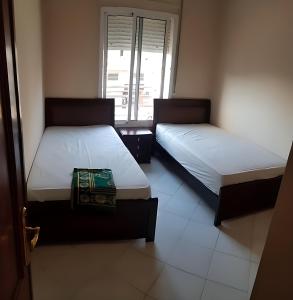 Giường trong phòng chung tại Appartements ahlan