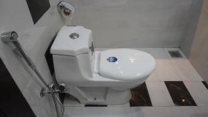 a bathroom with a white toilet in a stall at Go Guest House Lahore in Lahore
