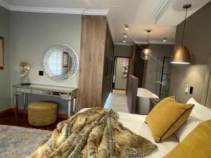 a bedroom with a bed and a mirror and a desk at 51 Carrington Way in Kimberley +25 photos