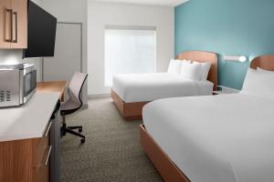 a hotel room with two beds and a tv at Element by Marriott Charlotte Uptown in Charlotte +24 photos