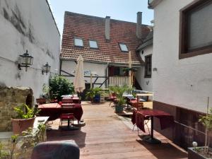 a patio with tables and chairs and a building at Gasthaus Zur Rose in Malsch