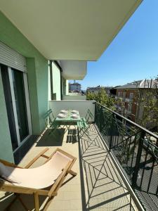 a balcony with chairs and a table on a building at Appartamento delle Vele in Bellaria-Igea Marina +6 photos