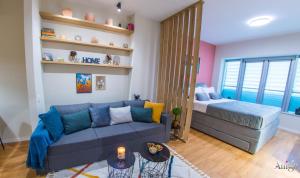 a living room with a couch and a bed at Iris Studio Apartment in Mostar
