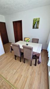 a dining room with a table and two chairs at Apartmani Proleće in Jošanička Banja +29 photos