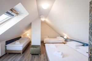 Posteľ alebo postele v izbe v ubytovaní Hotel Tanzberg Mikulov
