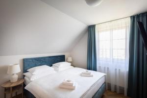 Posteľ alebo postele v izbe v ubytovaní Hotel Tanzberg Mikulov