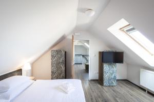 Posteľ alebo postele v izbe v ubytovaní Hotel Tanzberg Mikulov